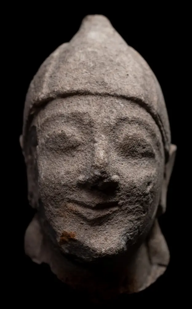 Limestone Head of a Beardless Votary in a Conical Helmet