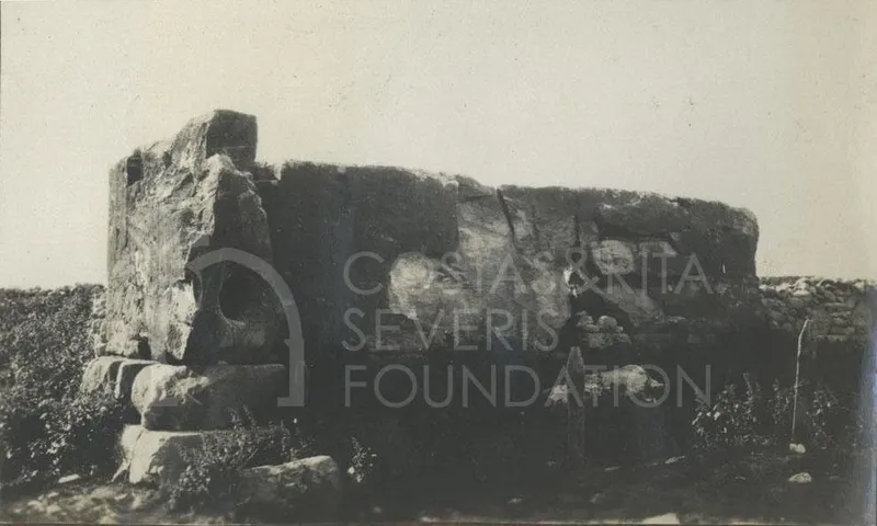 Large dressed stone blocks of a ruined wall at Palaepaphos with a figure standing beside them