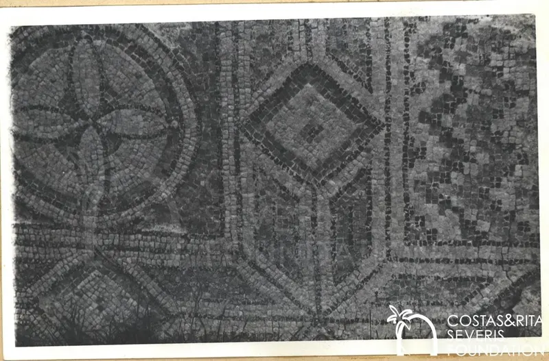 Geometric mosaic floor with a circular medallion and a diamond-shaped panel framed by dark bands