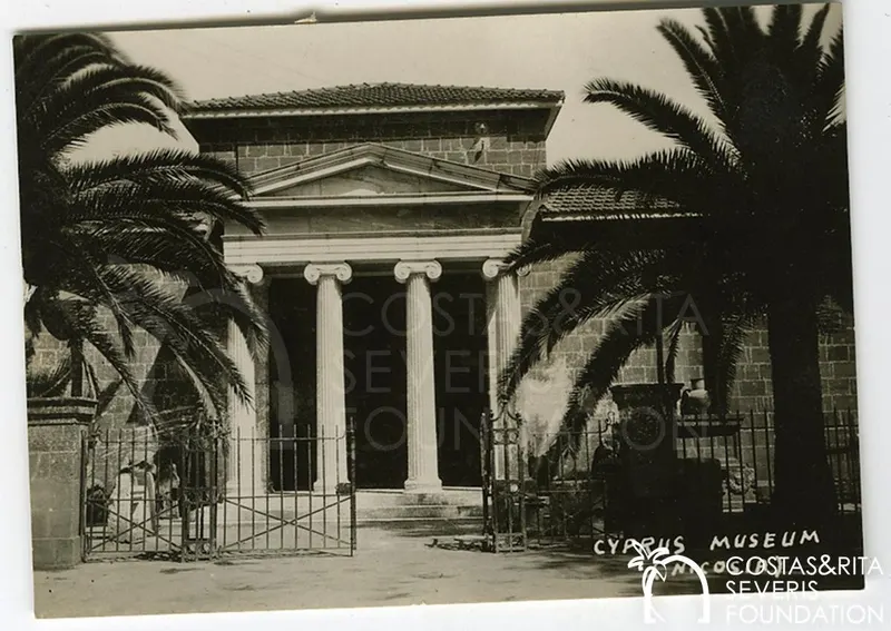 Front of the Cyprus Museum in Nicosia with Ionic columns, a pediment and palm trees on either side