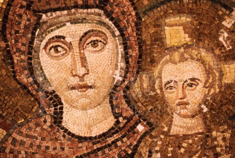 Close-up of a mosaic face of a woman in a dark-bordered halo, with a child's face beside her