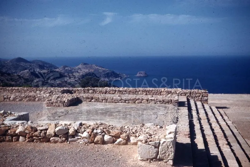 Stone wall foundations and a paved platform at Vouni Palace overlooking the sea