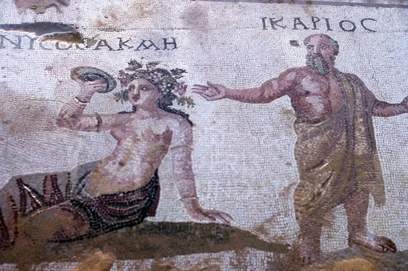 Mosaic floor detail: a bearded man with an outstretched arm stands beside a woman wearing a wreath of leaves
