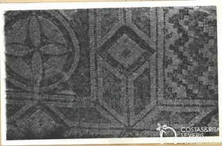 Geometric mosaic floor with a circular medallion and a diamond-shaped panel framed by dark bands