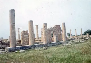 Standing columns and low ruined walls of the Sanctuary of Apollo Hylates at Kourion under a pale sky