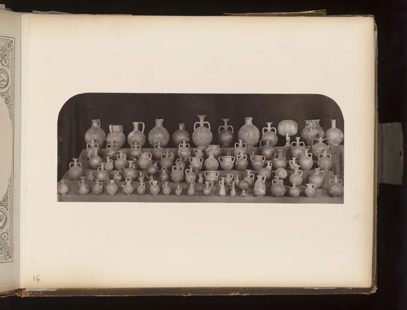 Many small and large jugs and juglets arranged in rows on shelves against a dark background.