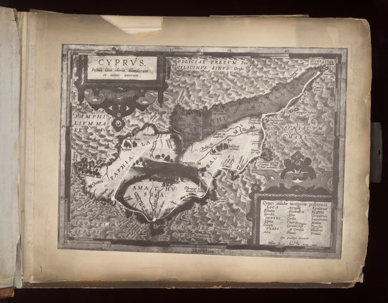 Engraved printed map of Cyprus with ornate title panel and legend, mounted on a cream album page