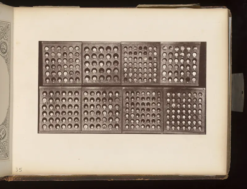 Eight wooden trays in two rows, each holding rows of small round objects in circular recesses