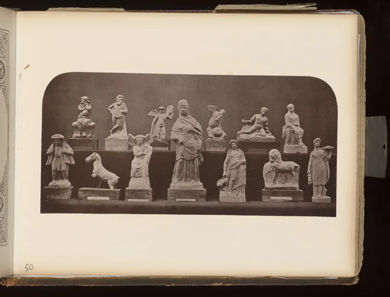 Fourteen small figurines of humans and animals arranged in two rows on wooden bases against a dark backdrop.