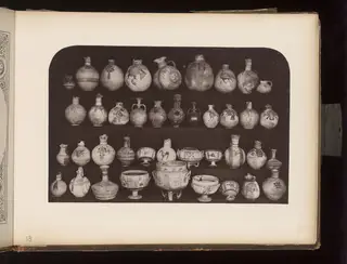 Painted terracotta jugs, juglets and bowls on shelves