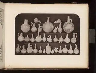 Terracotta jugs, juglets and flasks in three rows