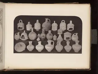 Pottery vessels, lamps and figurines in three rows