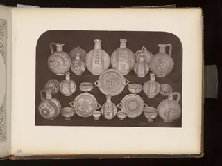 Terracotta jugs, bowls and dishes arranged in rows