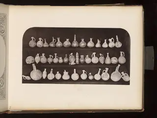 Terracotta juglets, jugs and bowls in three rows