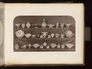 Terracotta vessels arranged on three shelves