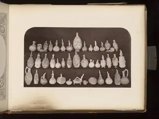 Terracotta jugs, juglets and bottles in three rows
