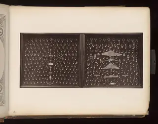 Gold and bronze jewellery in two wooden trays