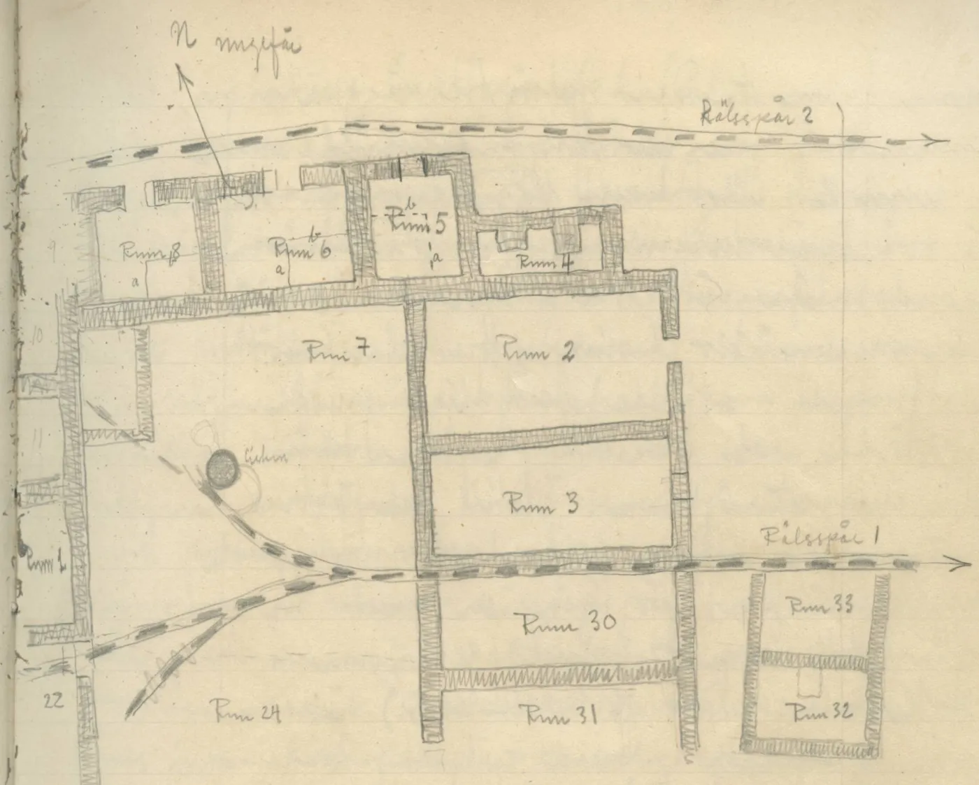 Architectural plan of rooms, walls, a circular feature and two rail tracks
