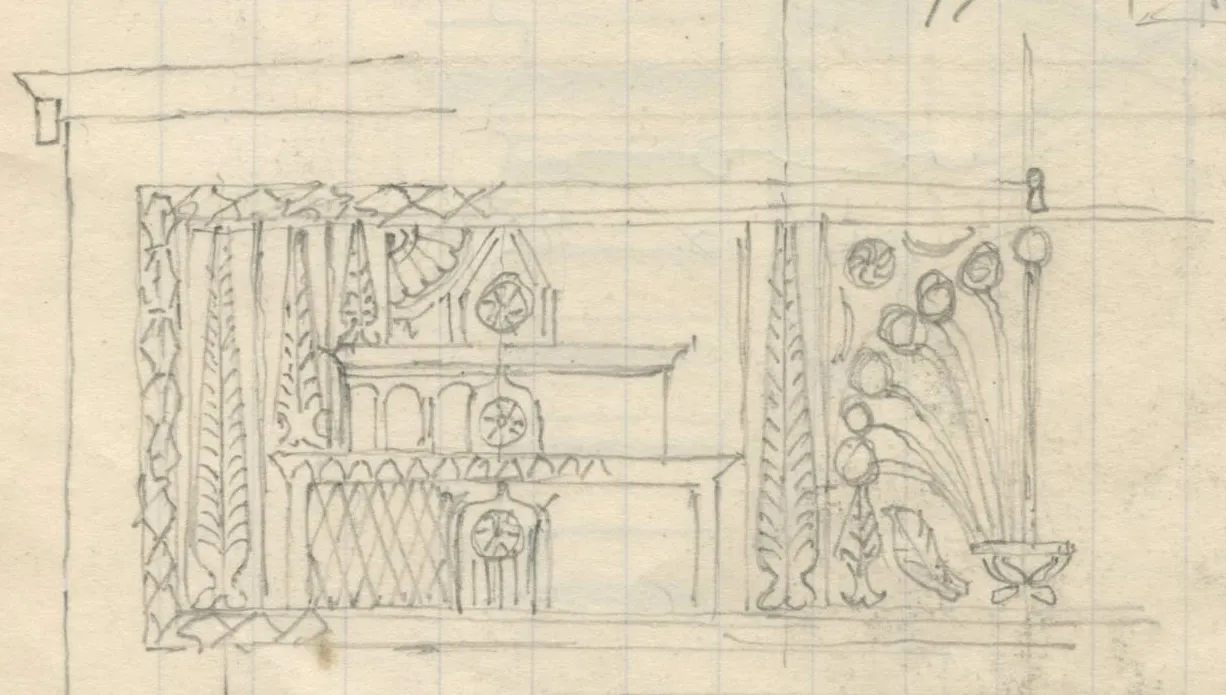 Front view of a chest with fluted legs and carved panel showing architectural and floral motifs