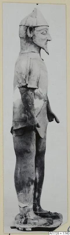 Terracotta statue of a standing figure in profile facing right, from Ayia Irini