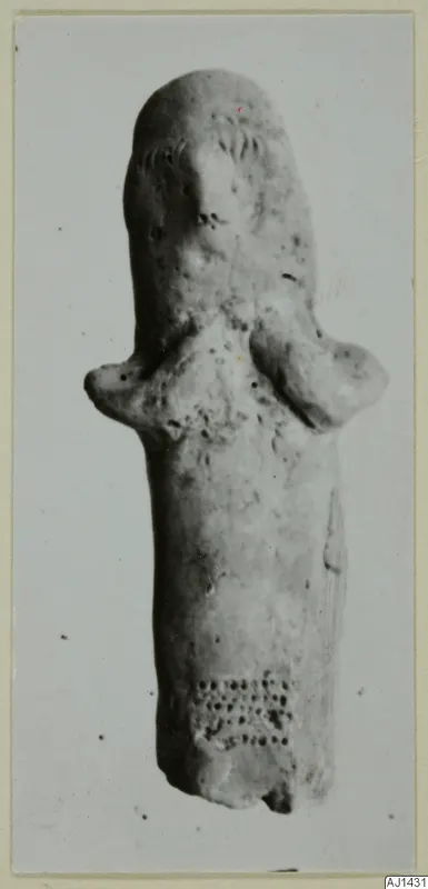 Terracotta figurine with a long body, short projecting arms and small pricked dots on its surface