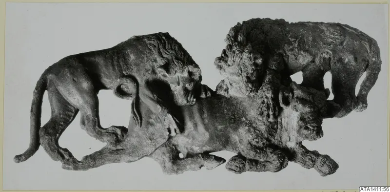 Bronze sculpture group of animals, including a lion, photographed against a plain background