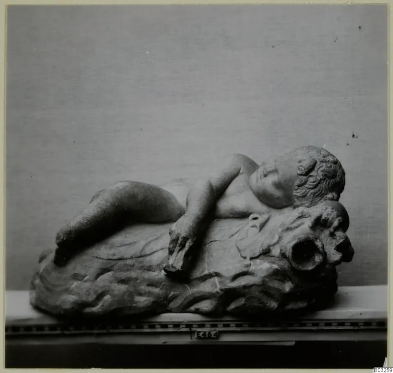 Marble sculpture of a sleeping child reclining on a carved rocky base, find from Enkomi