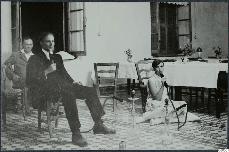 Woman smoking a hookah on a tiled terrace in Kyrenia, with two men seated nearby.
