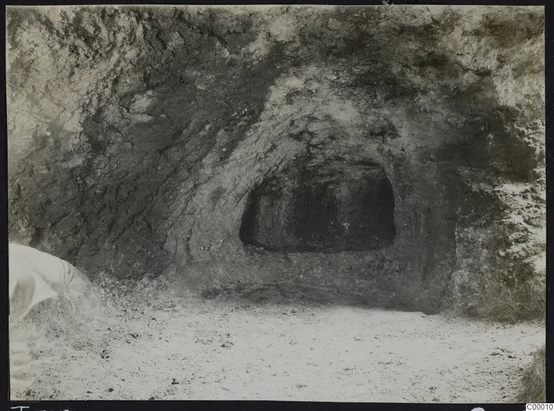 Rock-cut tomb chamber opening in a sandy cutting at Vrysi tou Barba, Lapithos, during excavation