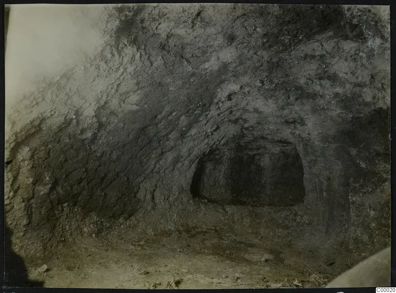 Tomb 302 at Vrysi tou Barba, Lapithos, during excavation, showing the opening of a tomb chamber in a rough earthen wall.