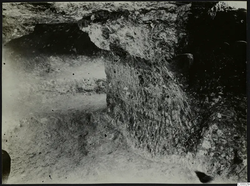 Tomb 315 at Lapithos, Vrysi tou Barba: tomb chamber with stones and a rounded object during excavation