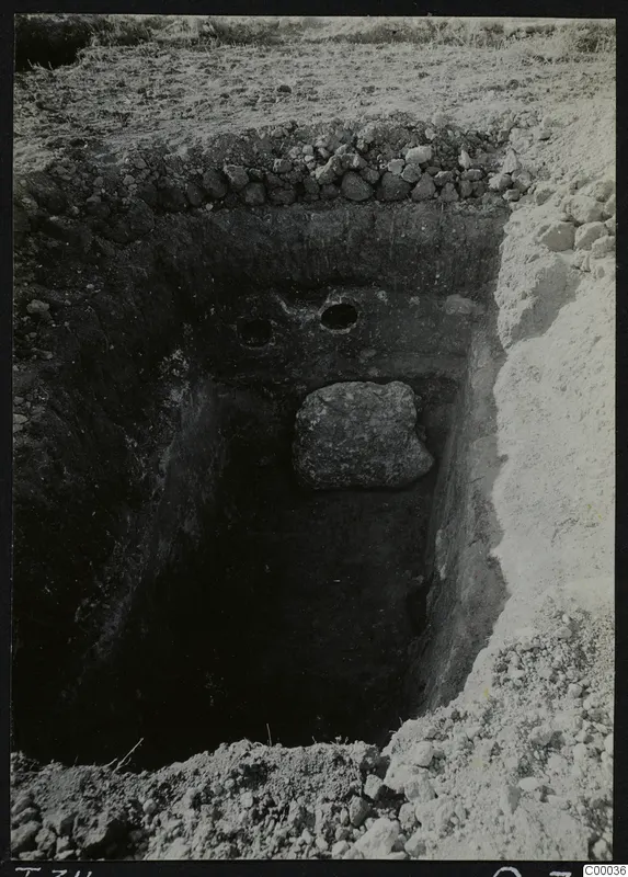 Excavated tomb chamber at Lapithos, Vrysi tou Barba, with a large stone lying in the pit