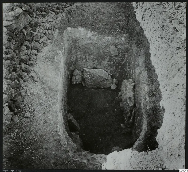 Excavated tomb chamber 313 at Lapithos, Vrysi tou Barba, with large stones lying in the pit during excavation
