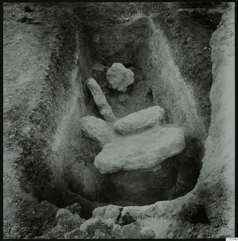 Tomb 322 at Lapithos, Vrysi tou Barba: excavated chamber with pale limestone slabs and blocks in the base.