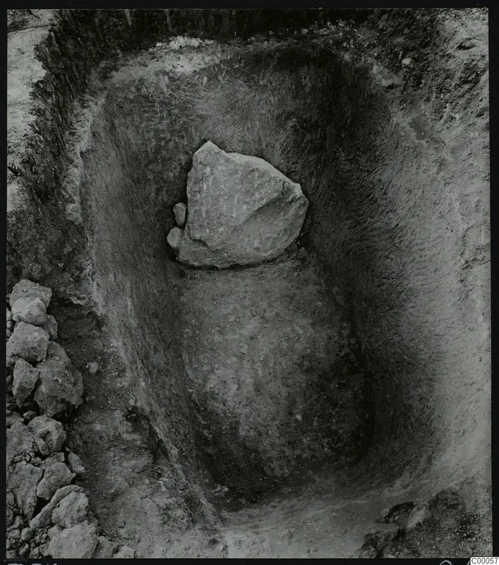 Tomb 318 at Lapithos during excavation, with a large stone lying in the cut of the tomb chamber