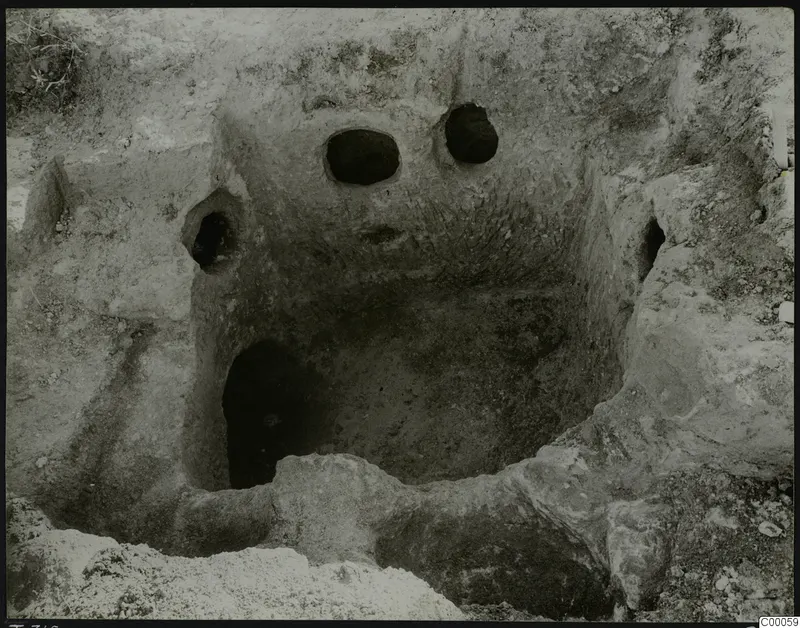 Tomb 316 at Lapithos, Vrysi tou Barba: excavated tomb chamber with round openings in its back wall