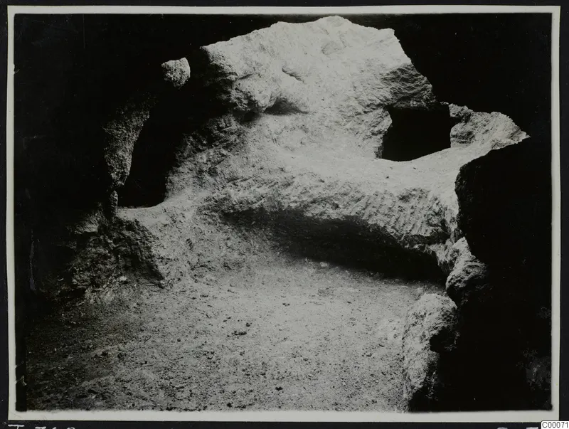 Tomb 306 at Lapithos, Vrysi tou Barba, during excavation: pale rock inside the tomb chamber above a sandy floor.