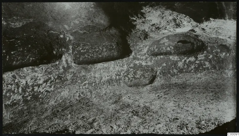 Rock-cut tomb chamber at Vrysi tou Barba, Lapithos, with rounded hollows in the floor during excavation