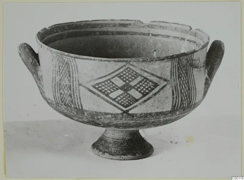 Pottery bowl with two handles and a footed base, painted with bands and lattice-filled diamond panels.