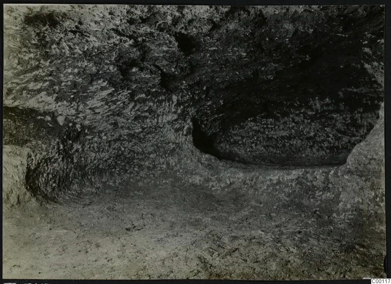 Interior of rock-cut Tomb 315 a at Vrysi tou Barba, Lapithos, showing the chamber walls and floor.