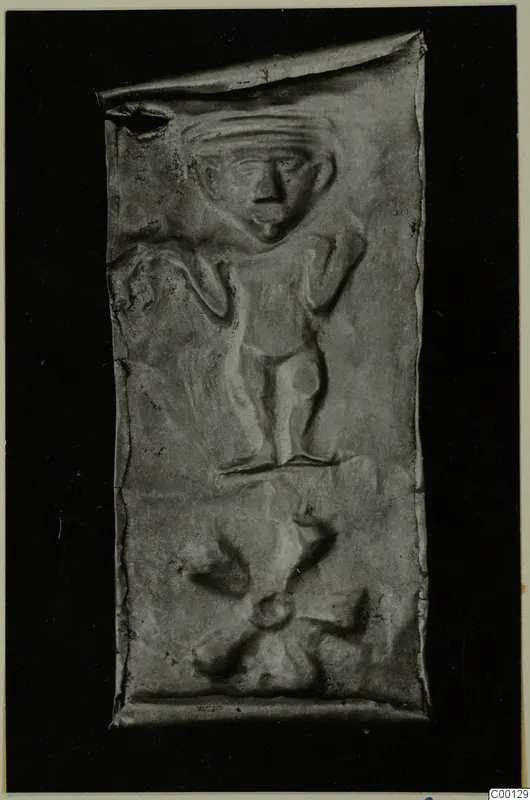 Rectangular metal plaque with a raised relief of a standing figure, from Lapithos Kastros tombs.