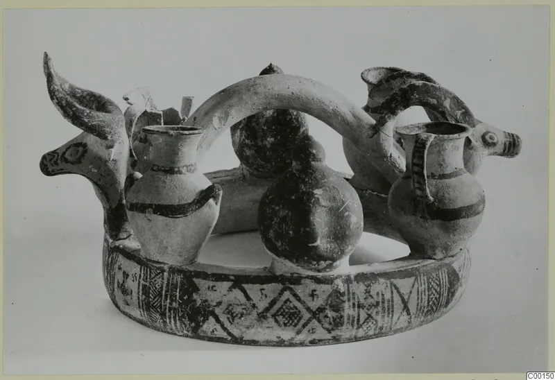 Pottery White Painted I - II from Lapithos: two animal heads with horns joined to painted jugs on a ring-shaped base.