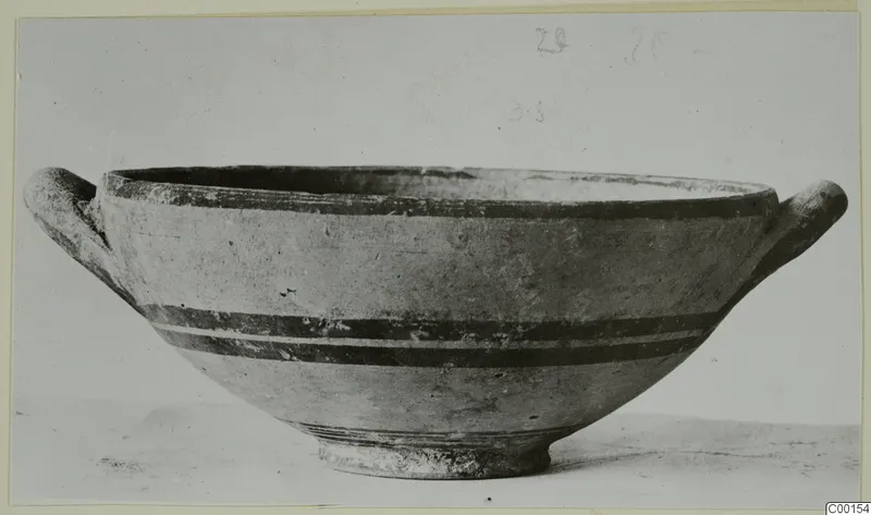 White Painted I bowl with two handles and dark painted bands, photographed on a card mount