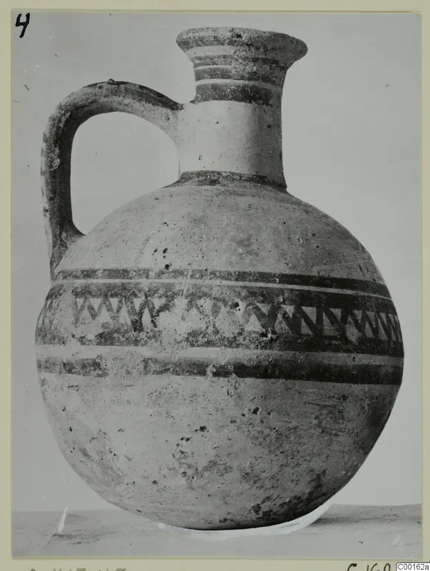 White Painted I jug from Lapithos with dark painted bands and a zigzag band around the body