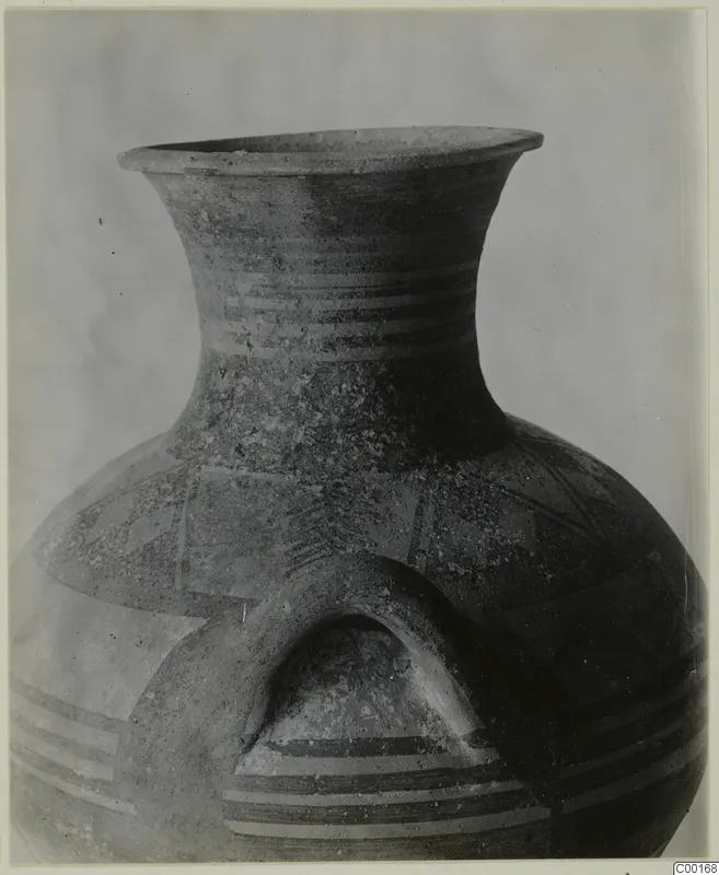 Striped pottery amphora from Lapithos, shown close up with a wide flaring neck and an arched handle.