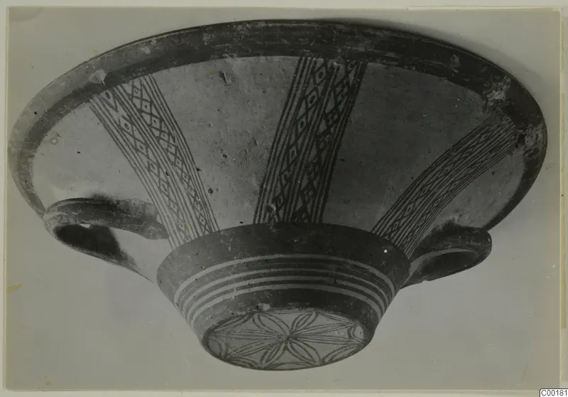 Pottery bowl from Lapithos with radiating diamond-lattice bands painted on the interior and a rosette on the base