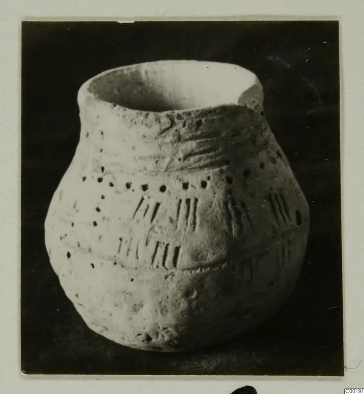 Coarse hand-made pottery jar with incised strokes and rows of small pierced dots