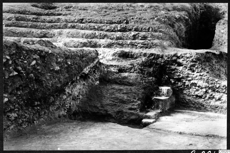 Excavated theatre at Soli showing rows of stone steps cut into earth, with a small flight of steps at right.