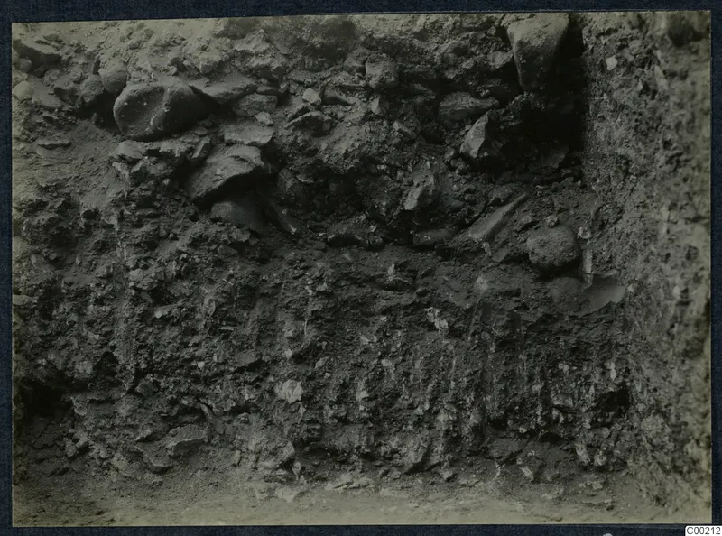 Excavated earth face with embedded stones during excavation of the theatre at Soli