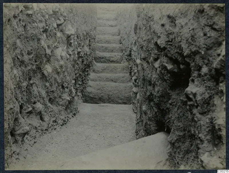Stone steps rising between earthen cut walls during excavation at Soli theatre